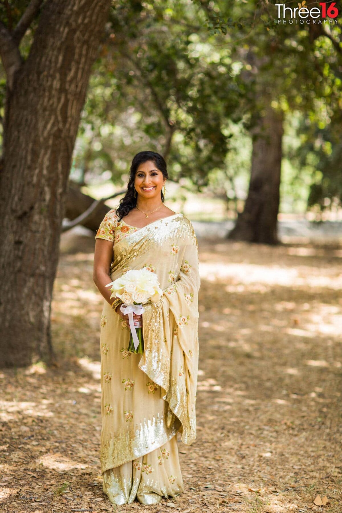 Beautiful Indian Bride poses with her bouquet for pictures after her wedding ceremony