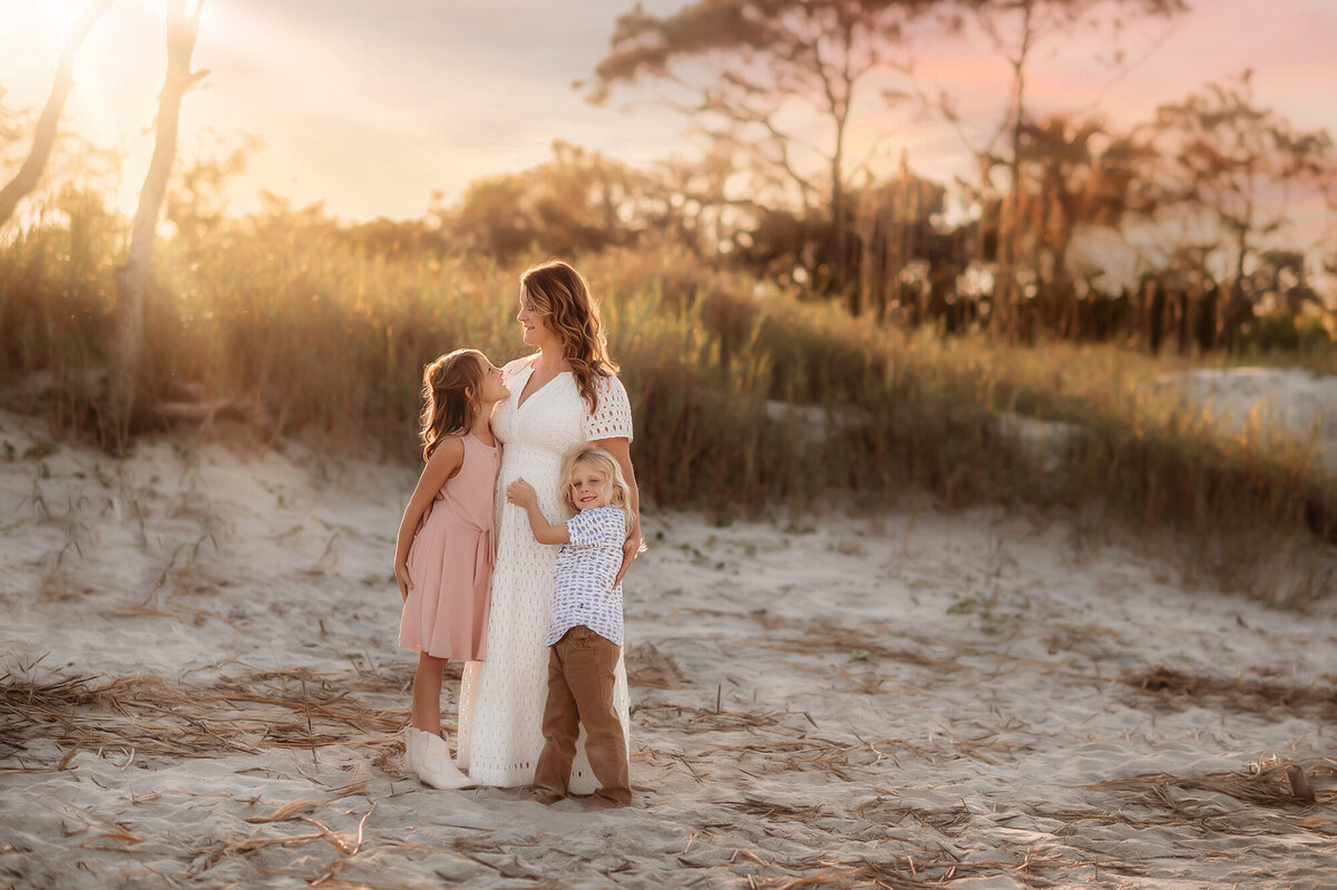 Mother embraces her children during Family Photos on Folly Beach.