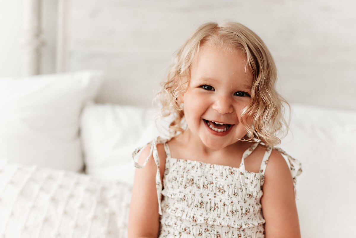 three year old girl smiling at Denver milestone photographer