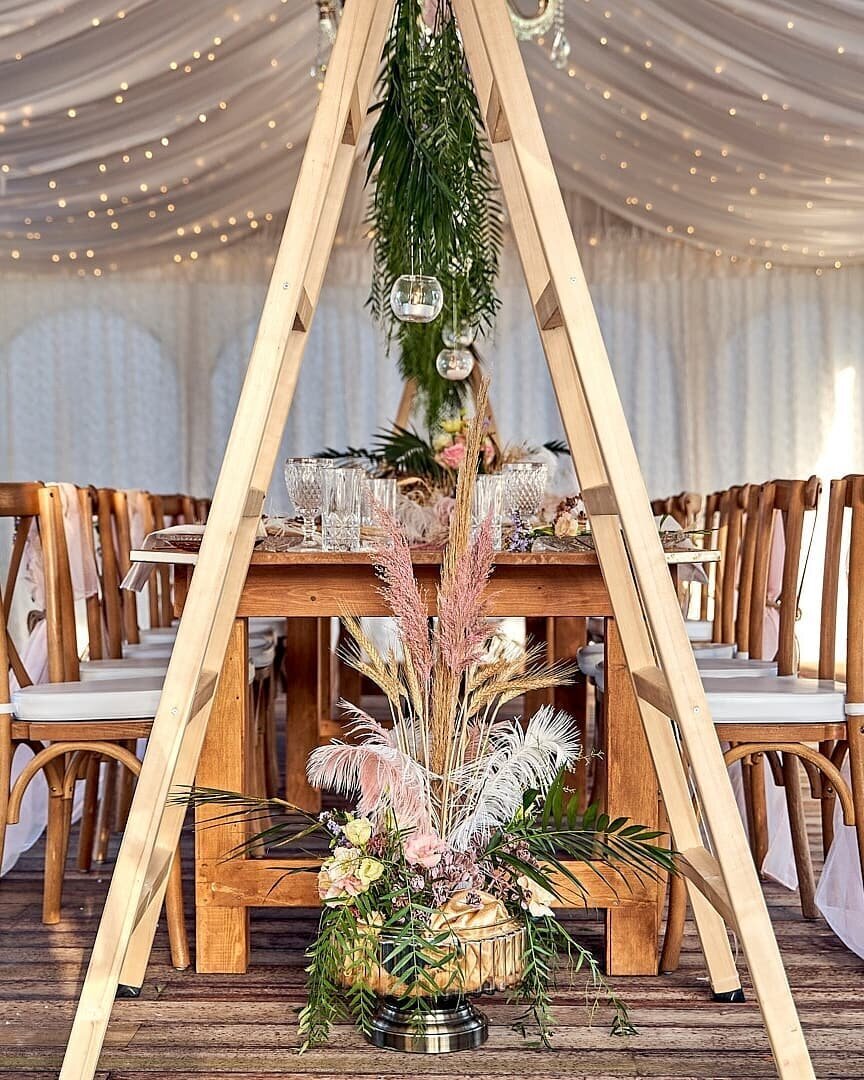 Wooden tables under a marquee  with rustic decor