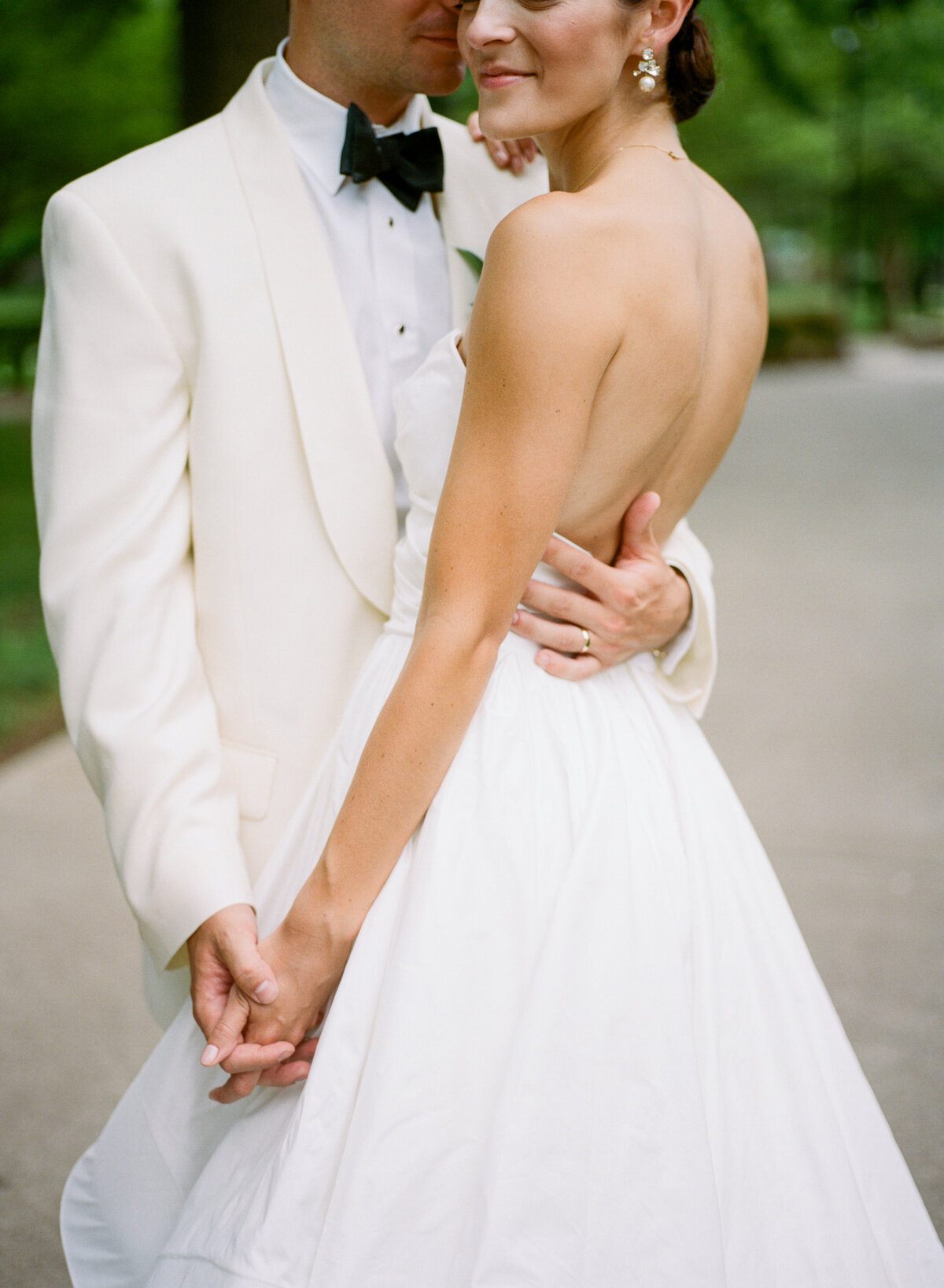 image of bride and groom holding hands outdoors