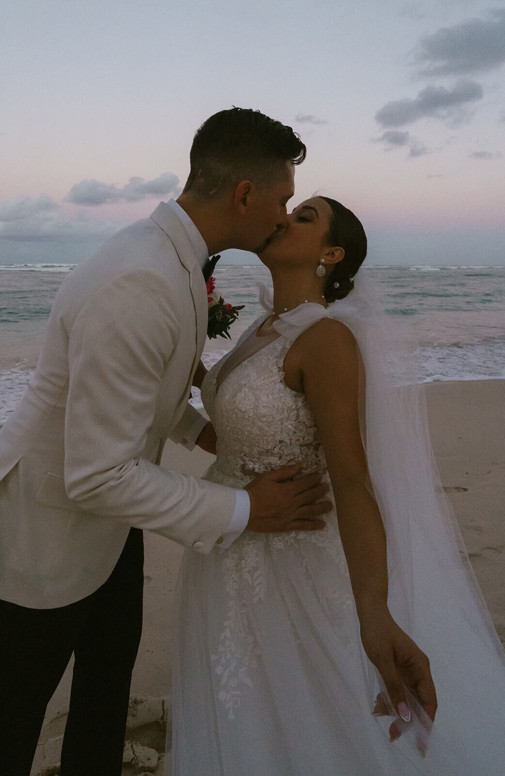 The-bride-and-groom-kissing-near-the-ocean
