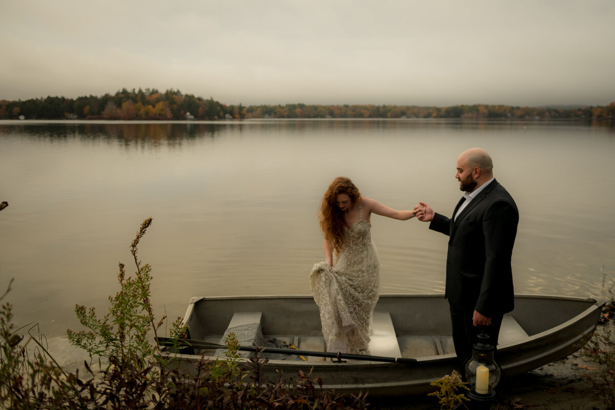 groom helping bride out of boat on elopement wedding day