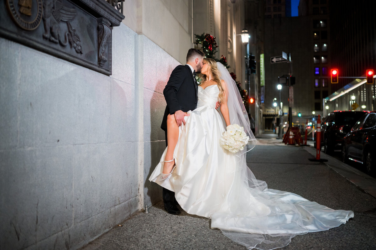 couple kissing at night time on street william penn place