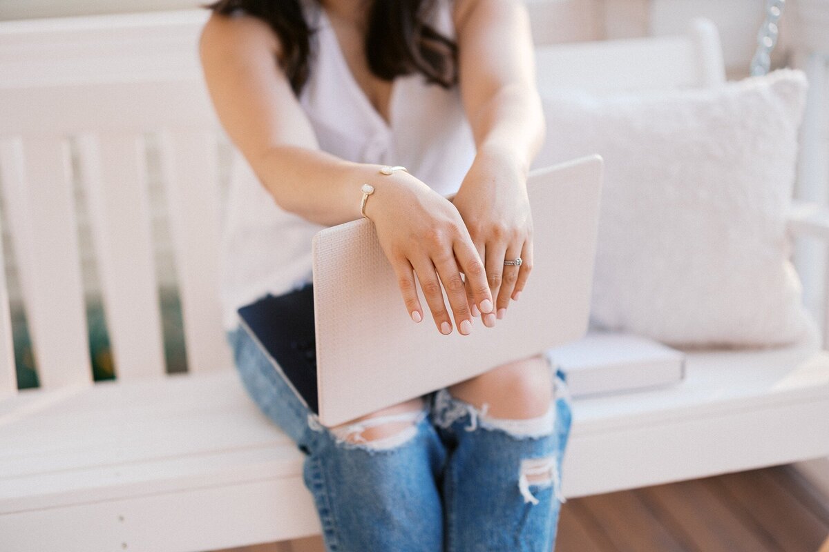 Website copywriter sits with laptop