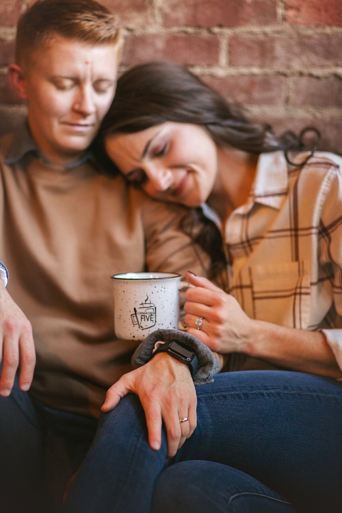 Couple-leaning-in-close-enjoying-warm-coffee-date-during-relaxed-lifestyle-photography-session-in-franklin-indiana-coffee-shop