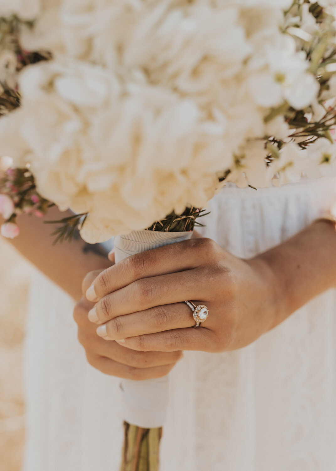 wedding ring on hand holding bouquet
