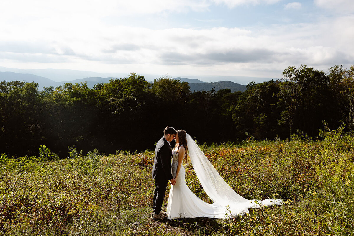 A couple standing close together in the mountains