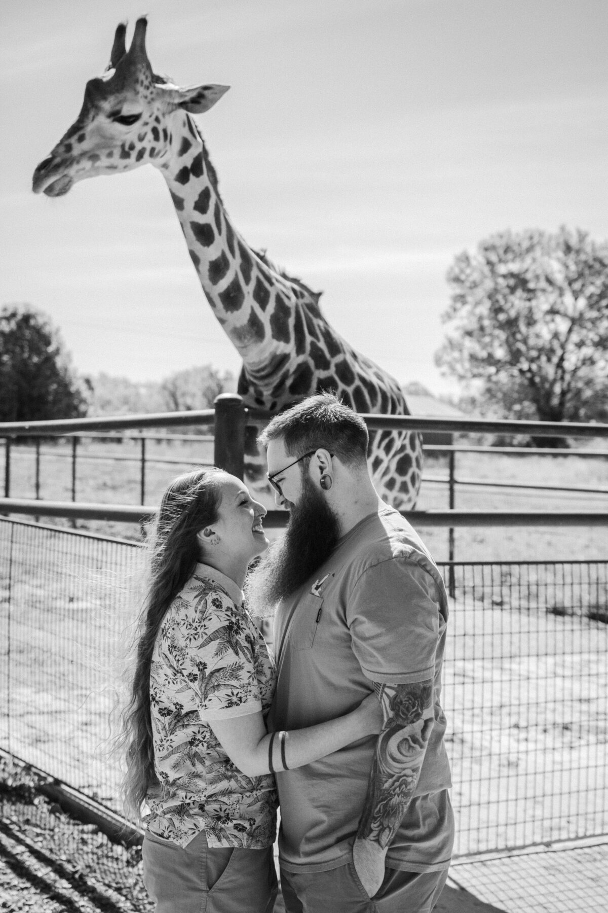 A tattooed couple laughing during their Springfield, MO elopement, captured by Chelsea Stanford.