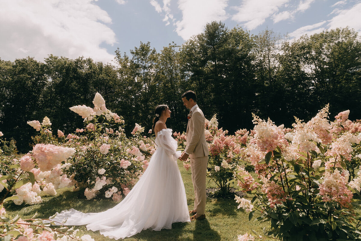 13.bride-groom-holding-hands-pink-hydrangeas-romantic-wedding