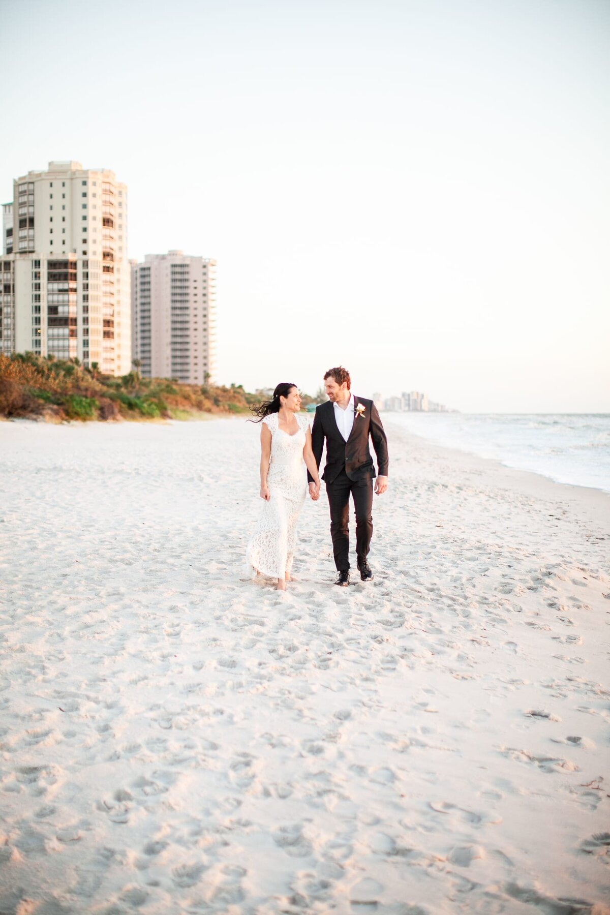bride-groom-walking-beach-naples-fl