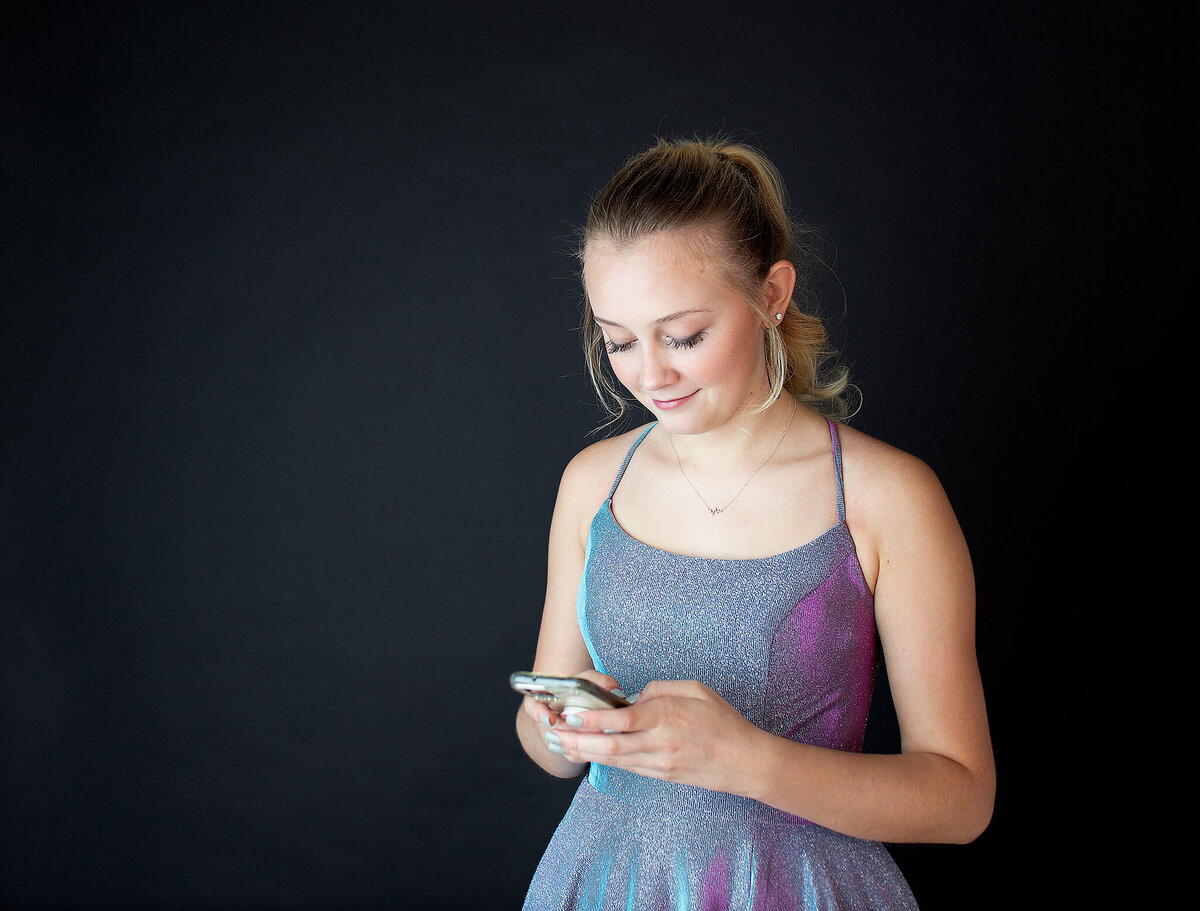 In studio prom pictures while she is on her phone