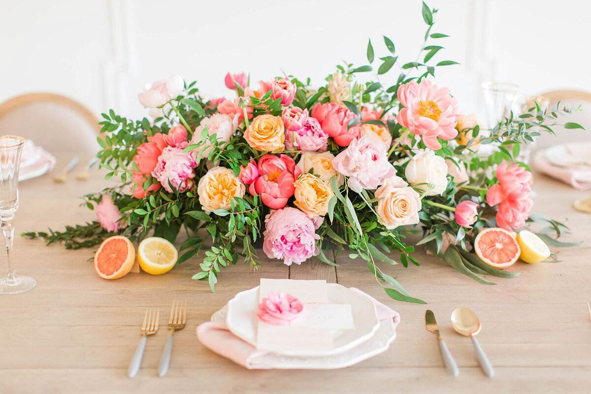 Colourful and modern tablescape, featuring tangerine, hot pink, fuchsia, and peach florals, styled by CNC Event Design, modern and elegant wedding planner based in Calgary, Alberta.  Featured on the Brontë Bride Vendor Guide.