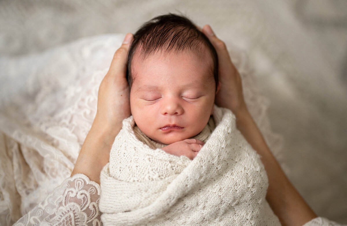 Newborn baby swaddled in a blanket