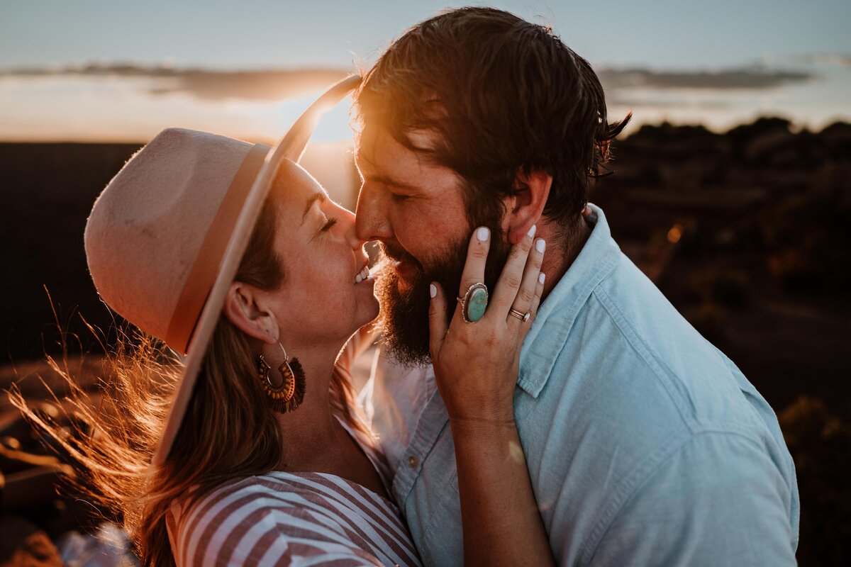 Engaged Couple kissing at sunset