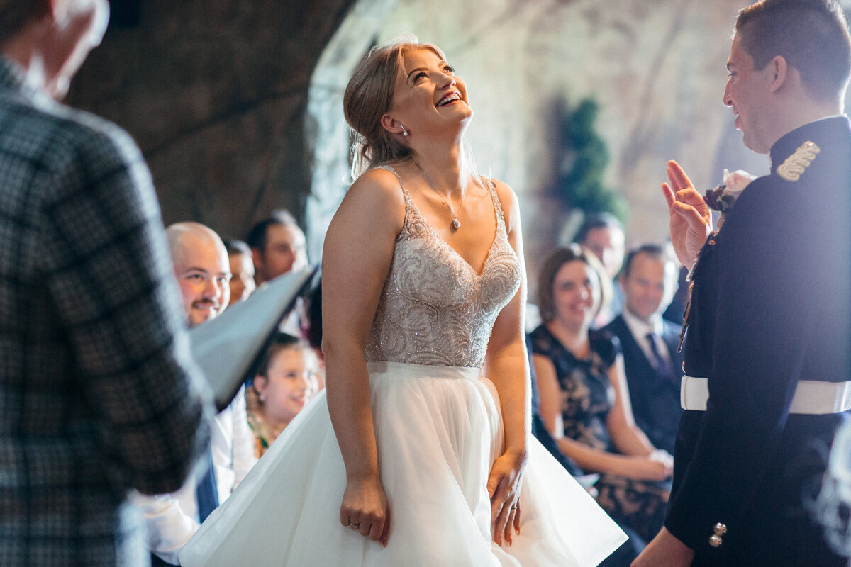 Groom looks stunned at bride as she enters the ceremony at Ocean Kave in Devon 