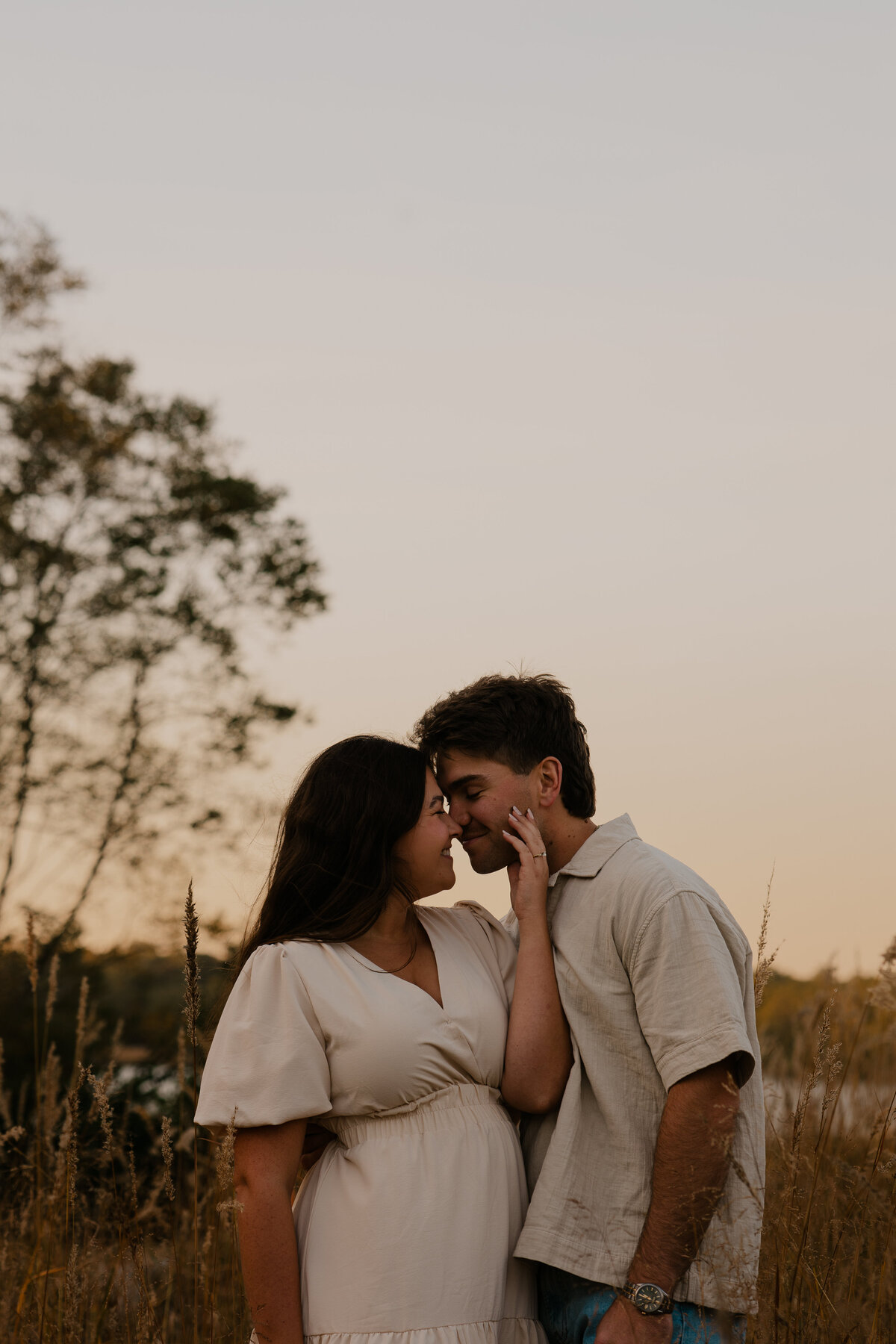 Couple's engagement session in Omaha during golden hour, surrounded by warm fall foliage – captured by Tori Nichole Photography. Authentic, romantic moments in a stunning autumnal setting, reflecting the beauty of the season and their love story.