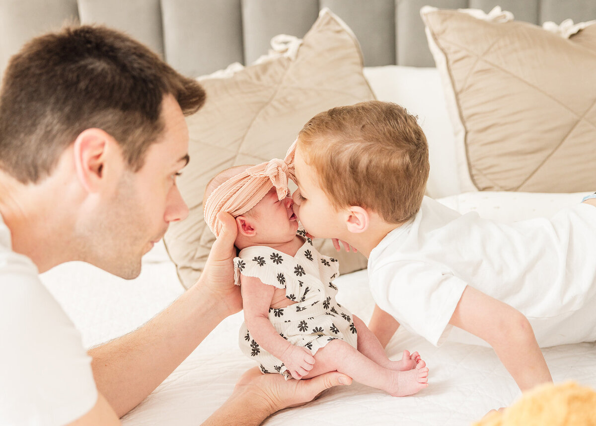 Father snuggling baby girl during relaxed in-home photo shoot in Orlando

