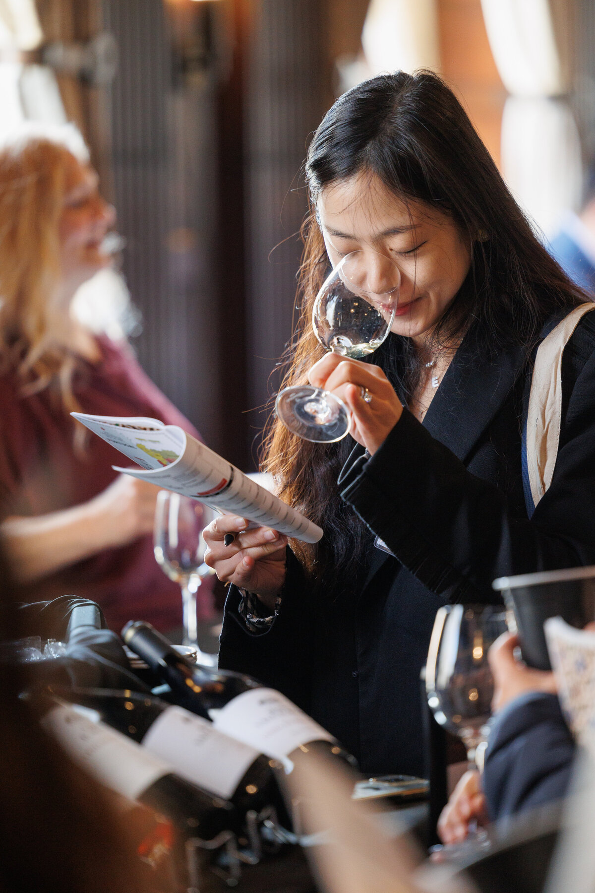 female holding a glass of wine