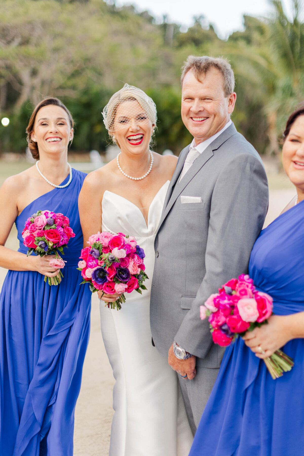 Bridal party laugh during their bridal party portraits at freedom Shores