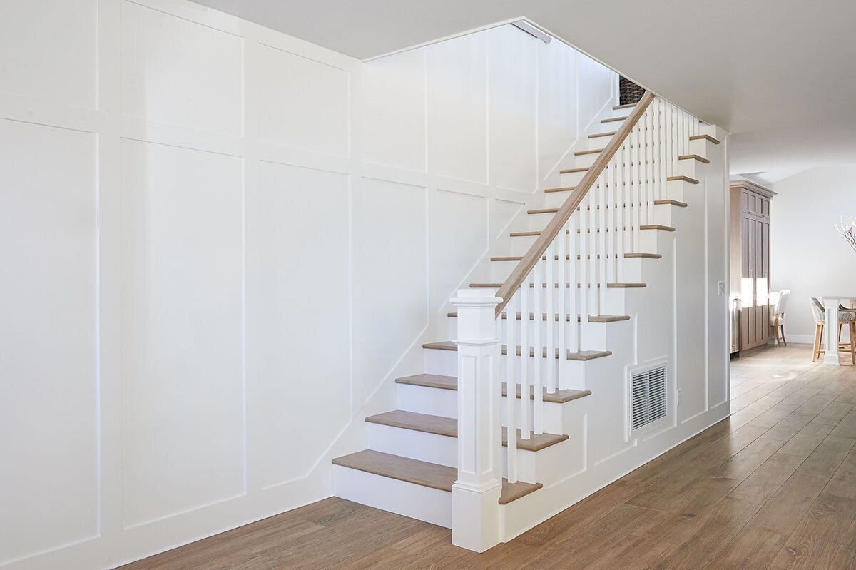 staircase with wall paneling