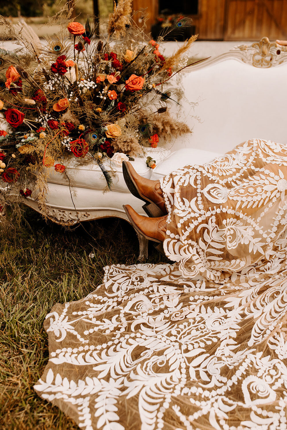 Bride’s boots peeking out under her intricate lace gown