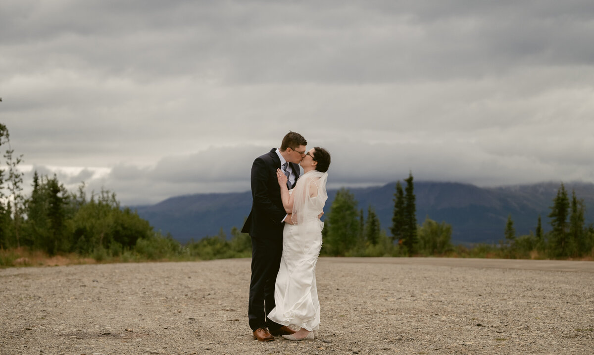 A bride and groom kiss in Alaska at their elopement