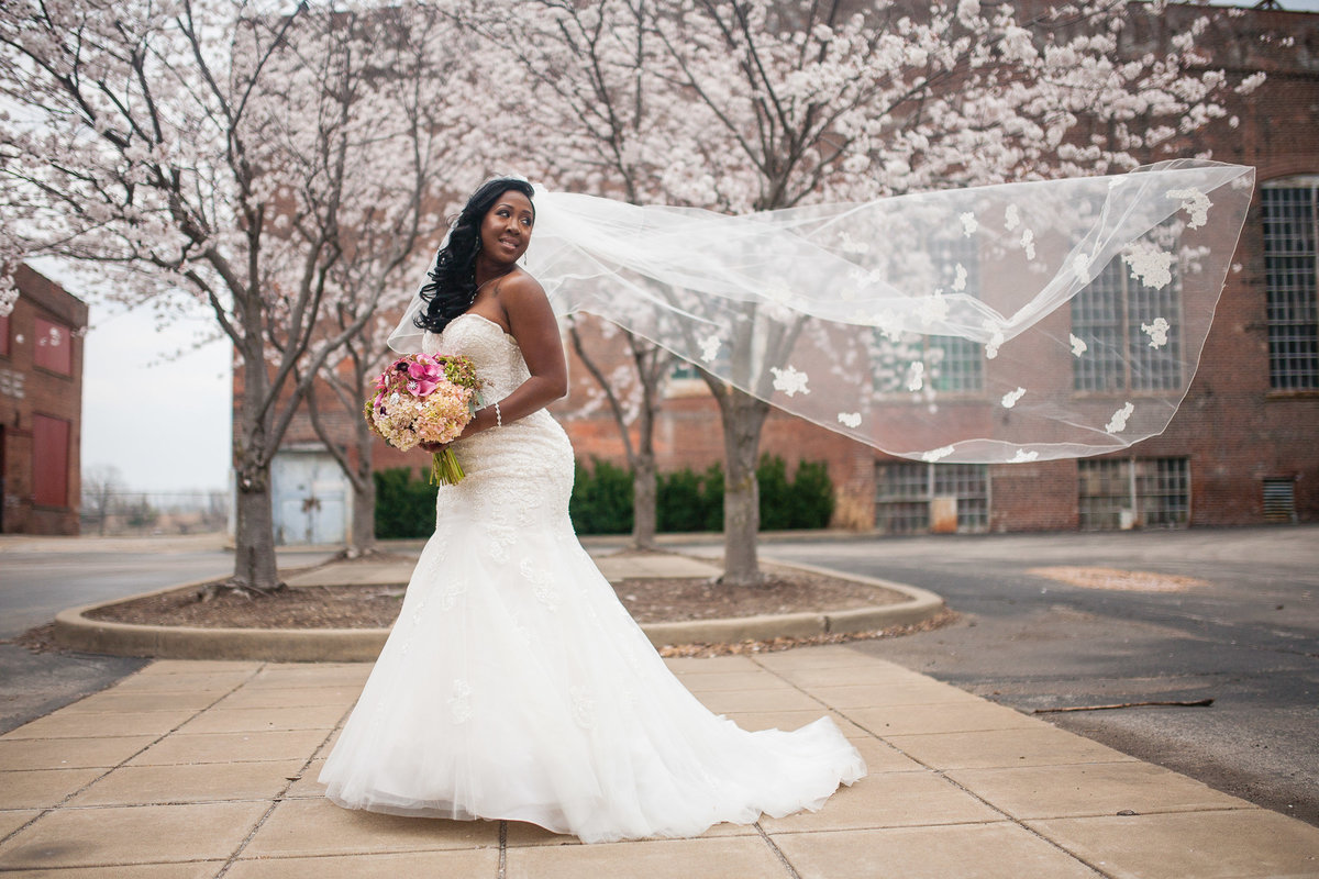 Bride poses near the Foundry Art Centre in Missouri, as a breeze takes her veil.
