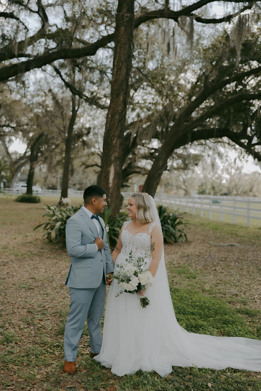 Bride and groom walking the scenic property at Uliana Estate, a Lakeland FL wedding venue.