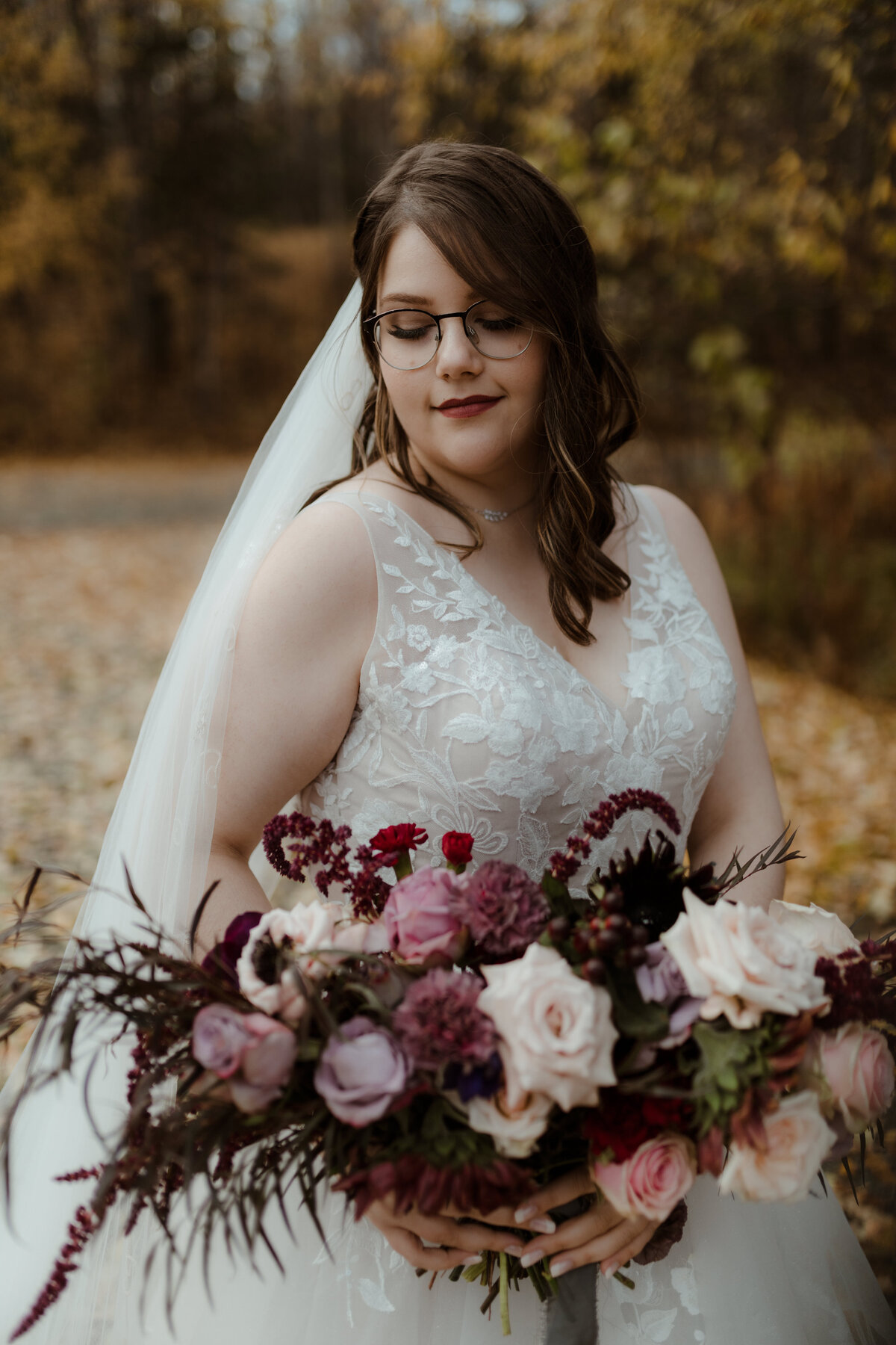 bride posing with flower bouquet