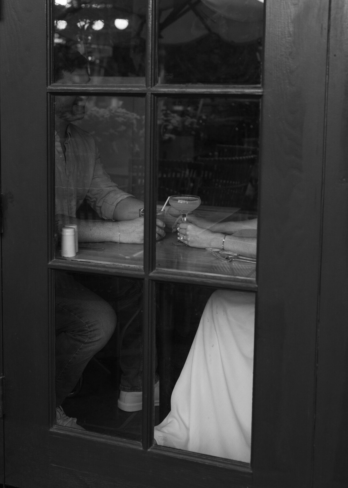 Couple holding hands inside the cocktail bar at The Scott Resort during engagement session
