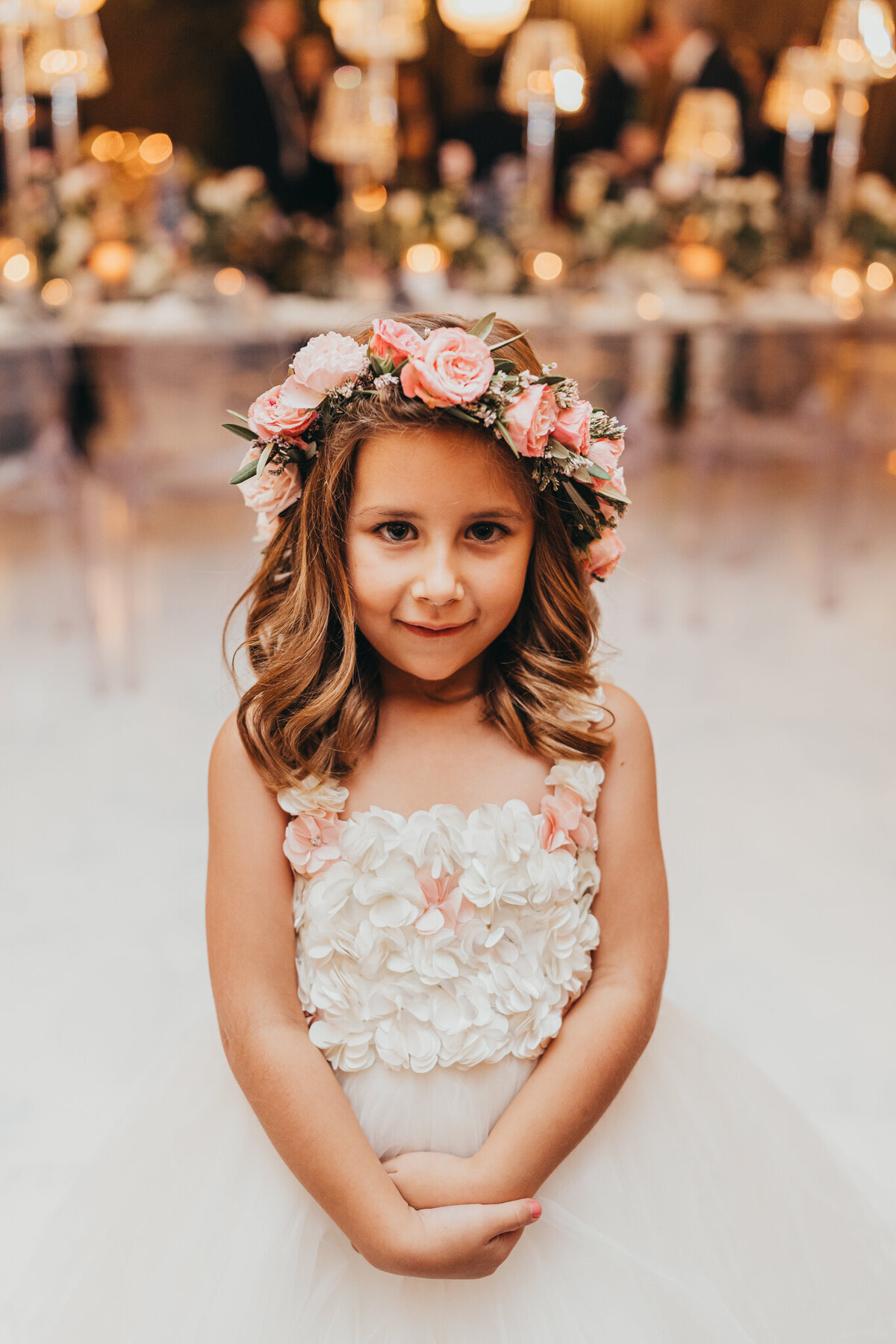 flower girl looks at camera during the reception