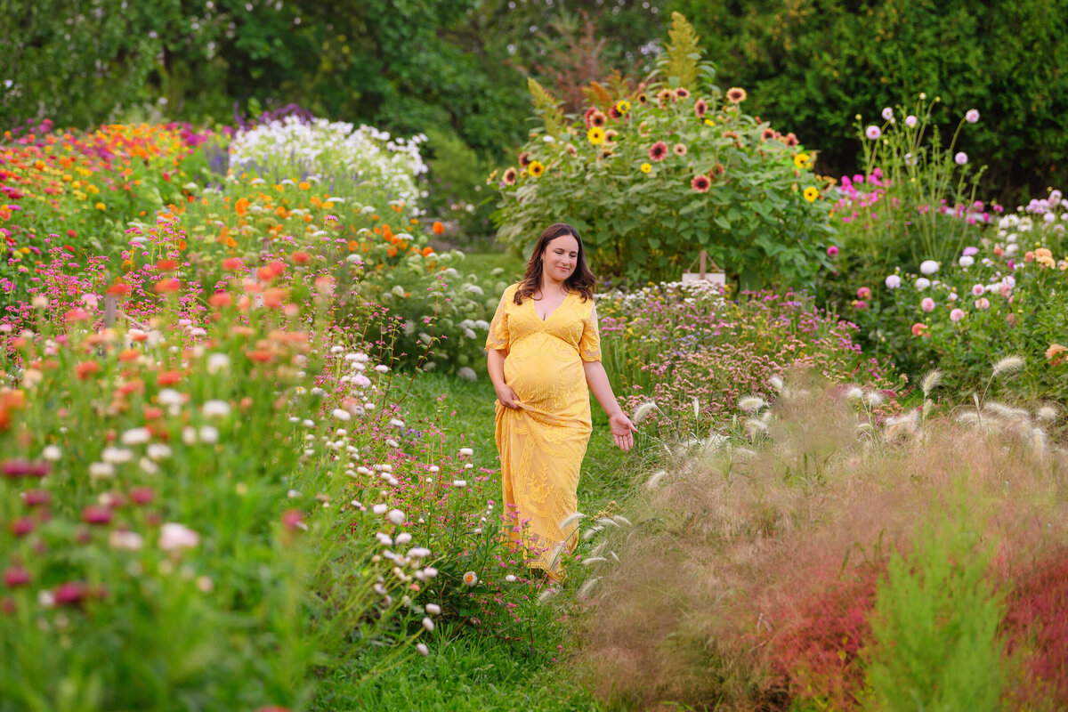 pregnant woman wearing a yellow maternity dress for her Burlington, On outdoor summer maternity photography session