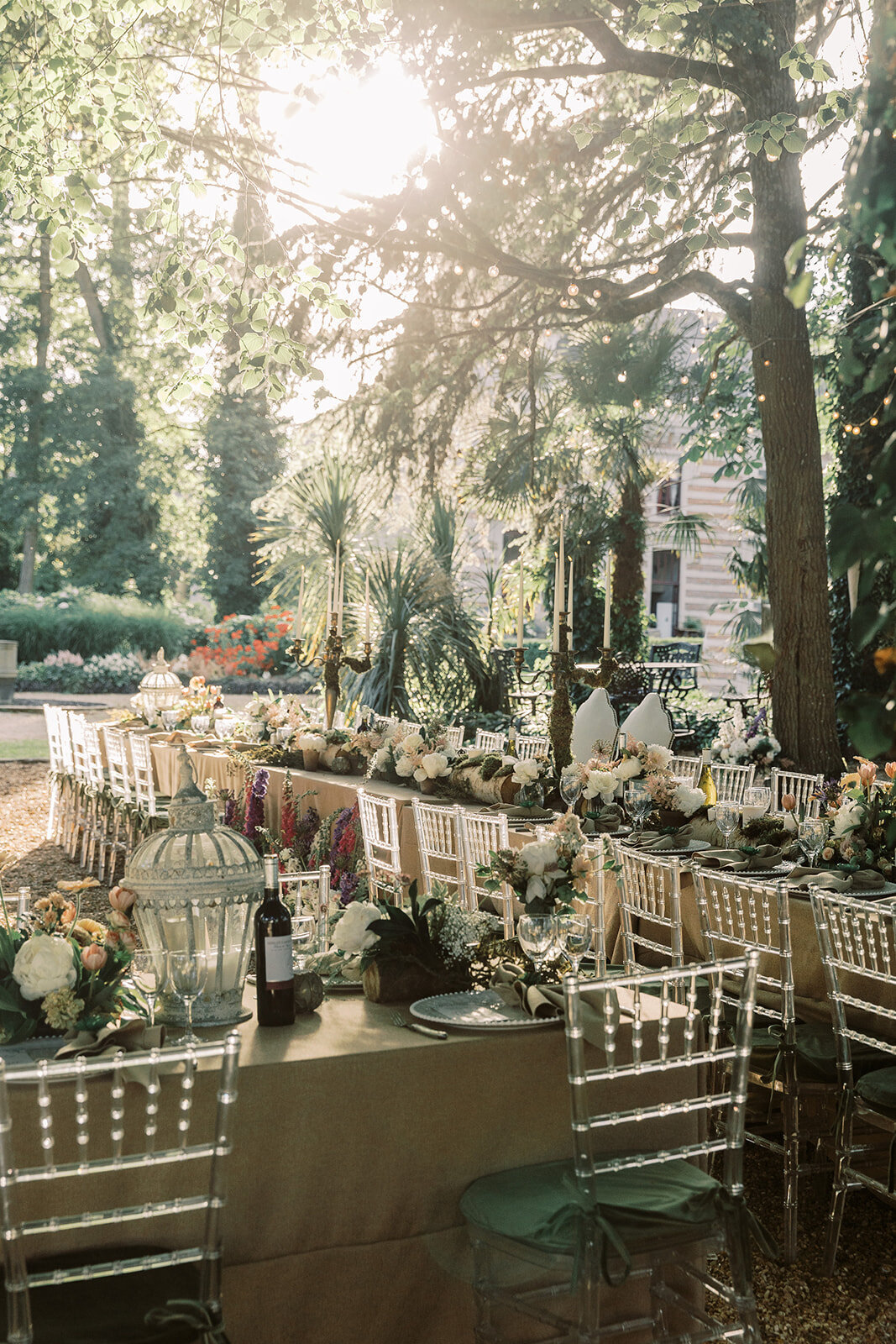 Beautifully arranged table for a pre-wedding dinner party in the gardens of Château Challain, captured in elegant, romantic fine-art photography.