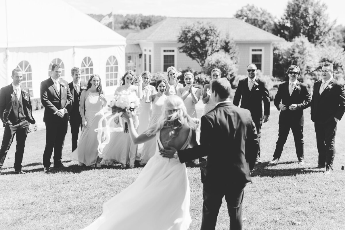 black and white photo of bride and groom with wedding party