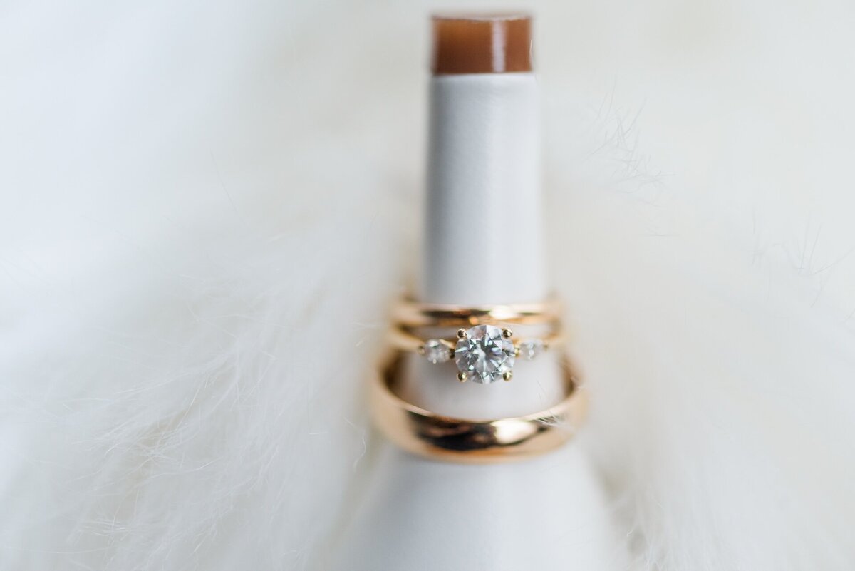 close up of wedding tings on a bottle neck