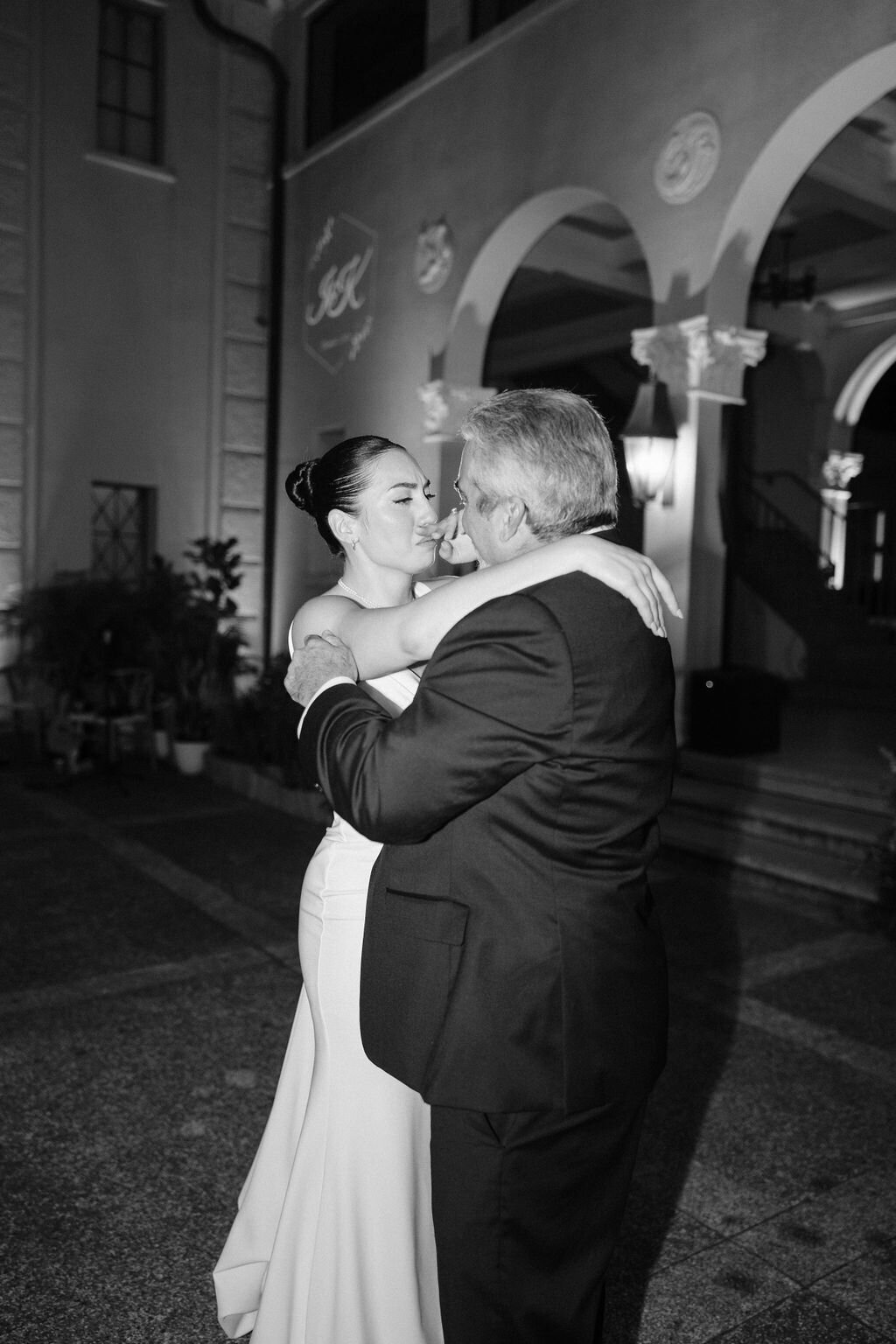 bride crying with her father during father daughter dance in black and white