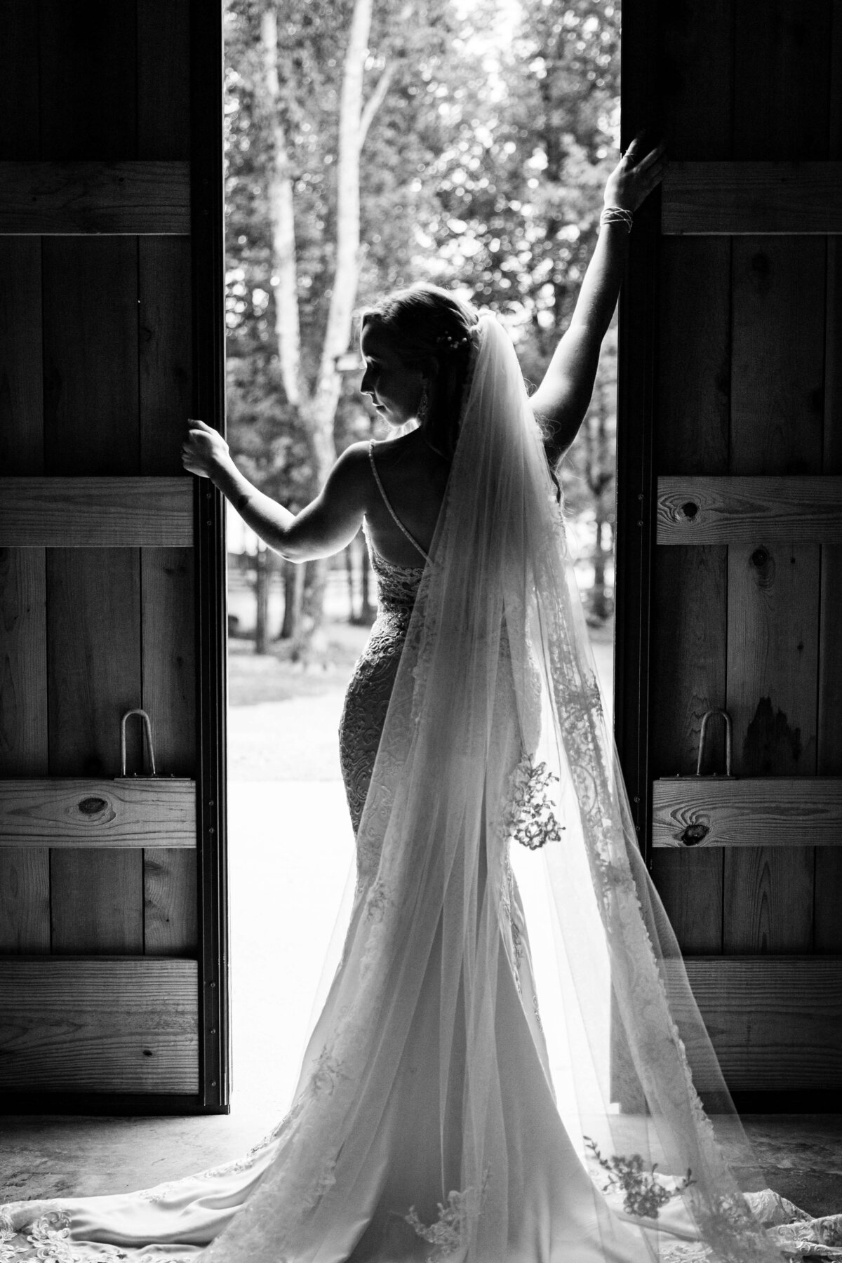 Bride standing by wooden doors at Tennessee wedding