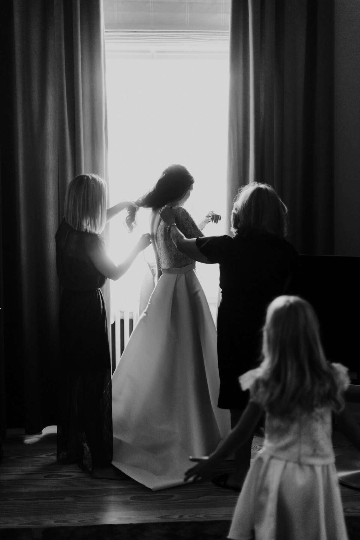 bride getting help with dress