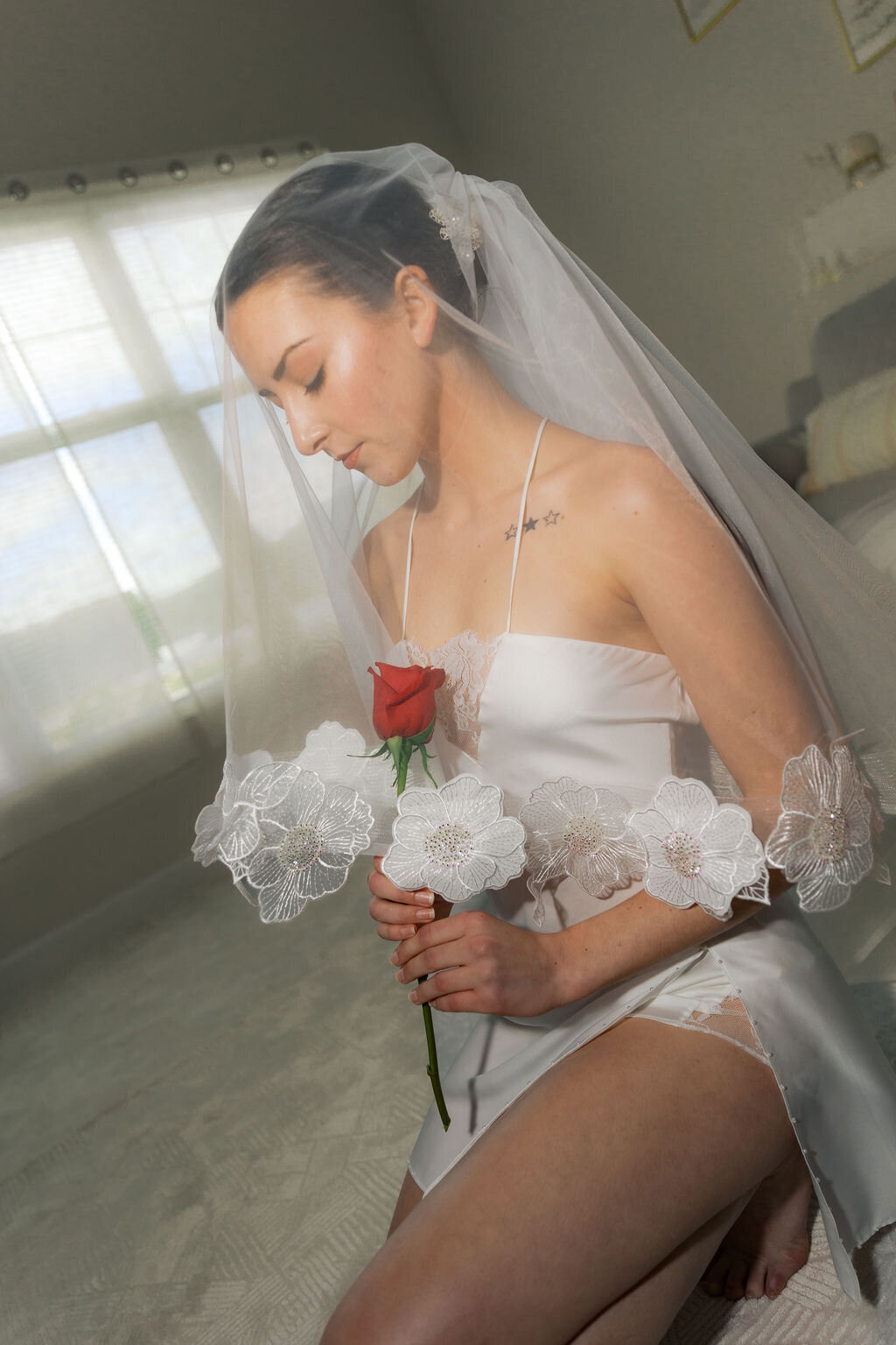 Bride relaxing in soft ivory slip dress during honeymoon morning
