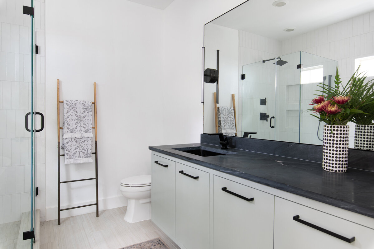 hello-home-sleek-modern-bathroom-design-black-countertops-glass-shower-austin-4