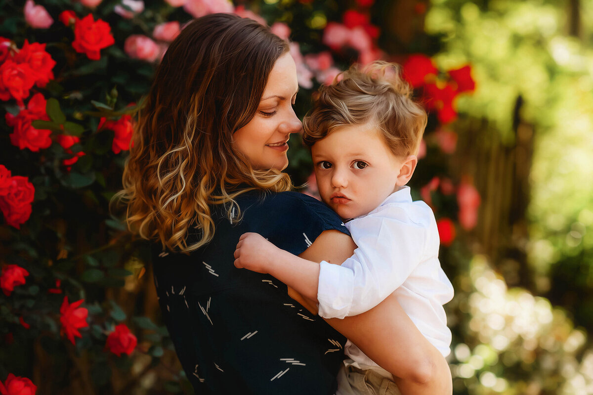 Mother embraces her baby during baby photoshoot in Charleston, SC.