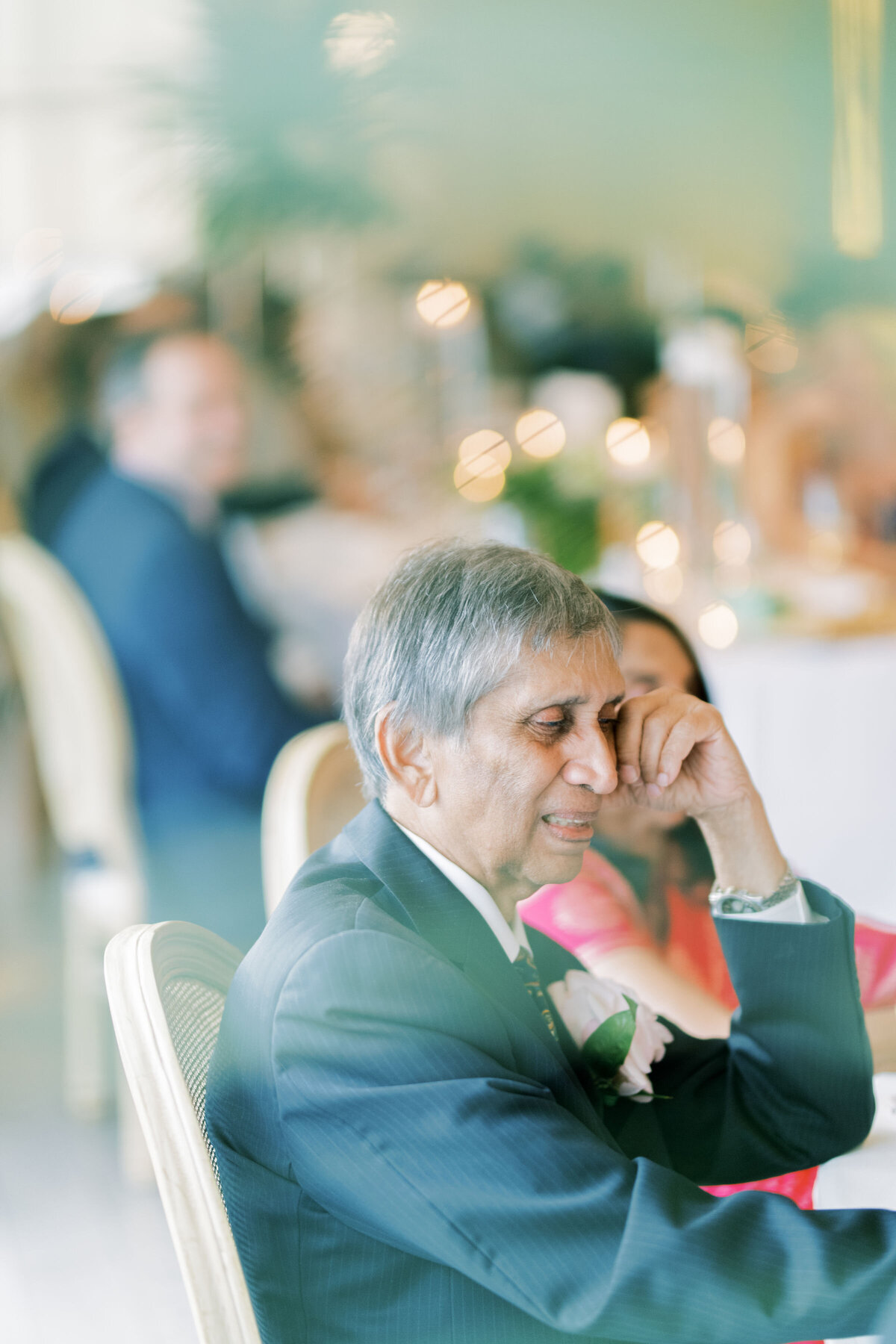 Portraits of brides father sitting and having an emotional moment during speeches