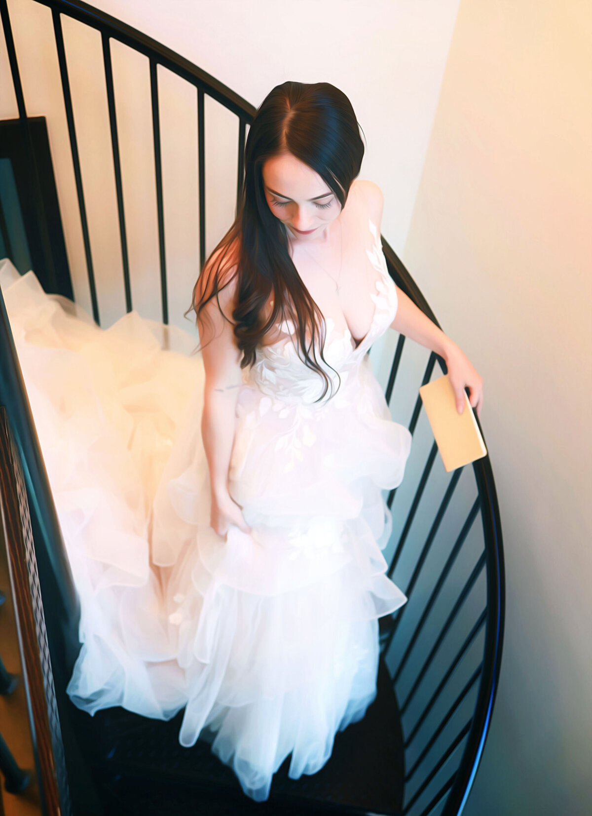 Beautiful bride with dark hair walking down a spiral staircase,