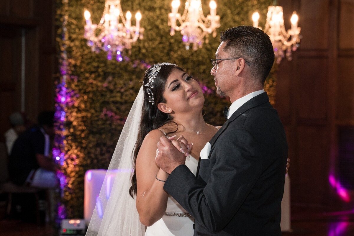 Emotional father-daughter dance under chandeliers at Union Club Hotel wedding reception.