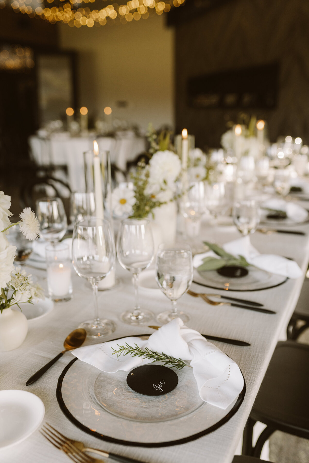 White flowers, with a black menu on plate