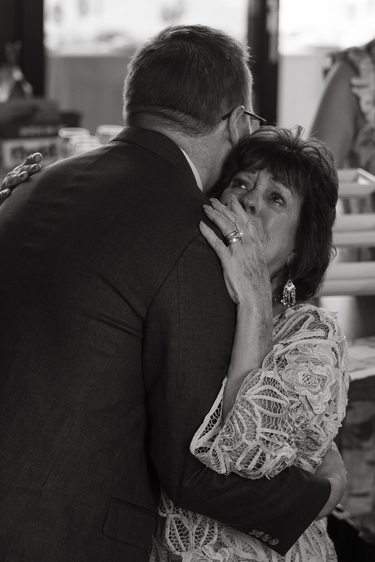 grandma hugs grandson emotionally on wedding day