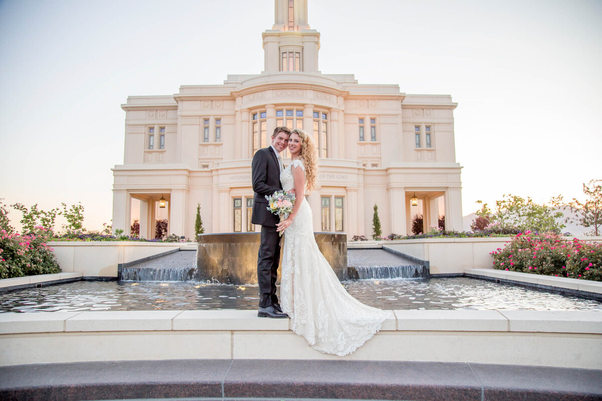 a wedding couple in front of  the payson lds temple at sunset