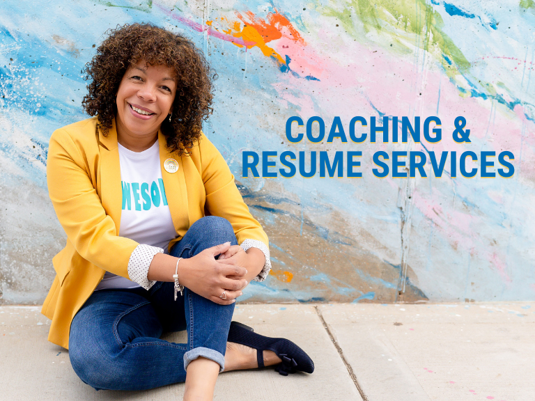 Photo of Michelle McKown-Cambell sitting on a sidewalk in jeans, a white shirt that says AWESOME, and a yellow blazer with an abstract graffiti wall behind her. Photo overlayed with text that reads, "Coaching & Resume Services"