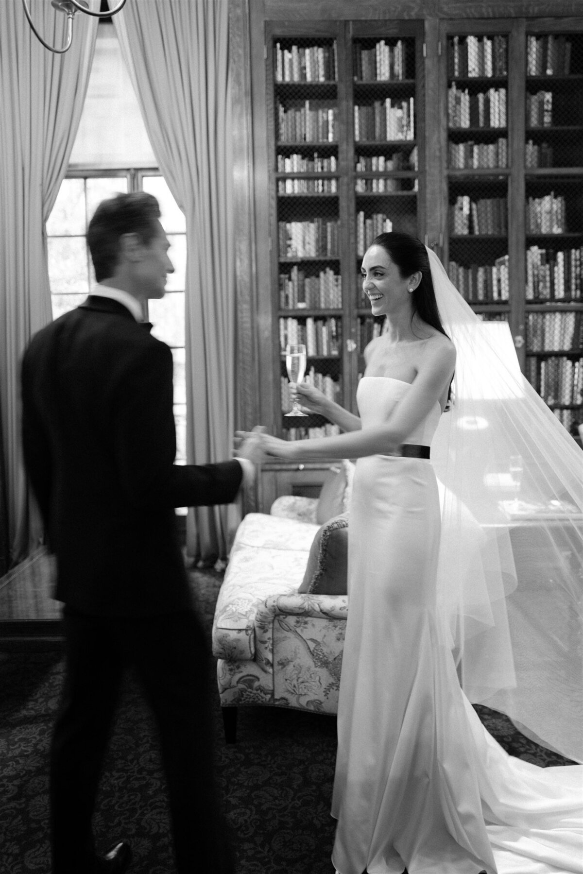 Bride and groom after wedding ceremony in library in black and white photography